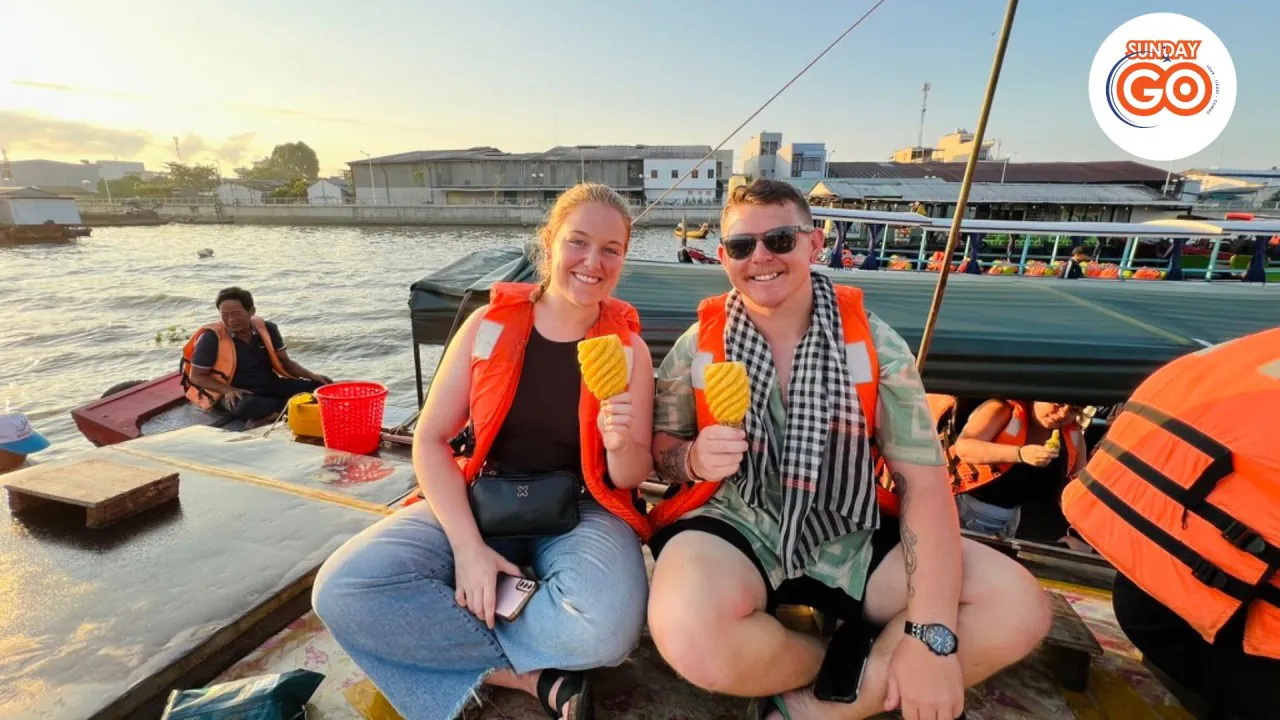 Can Tho floating market and Tra Su forest tour (Private) 34 Enjoy fresh pineapple in Can Tho floating market